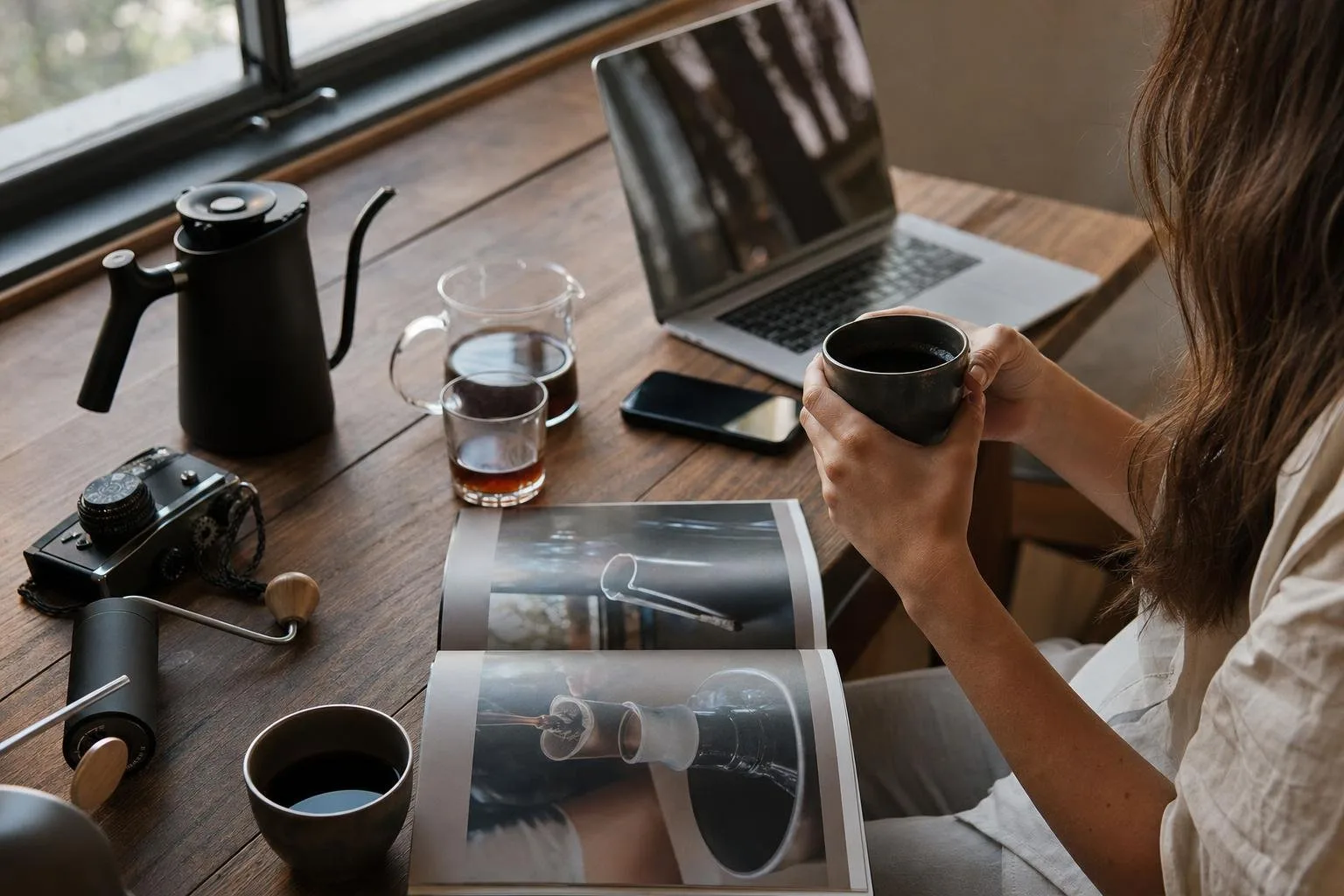 Coffee beans and brewing gear arranged on a dark surface